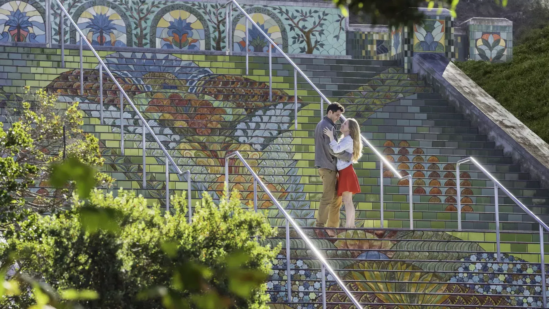 Photo taken from an angle of a couple standing on Lincoln Park's colorful tiled steps